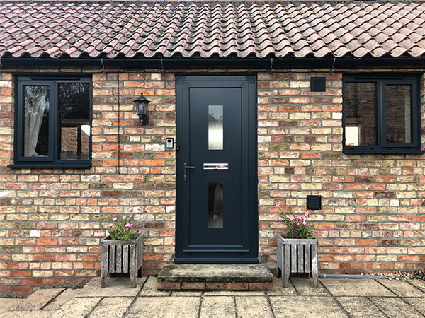 2 black aluminium windows with a black aluminium front door.