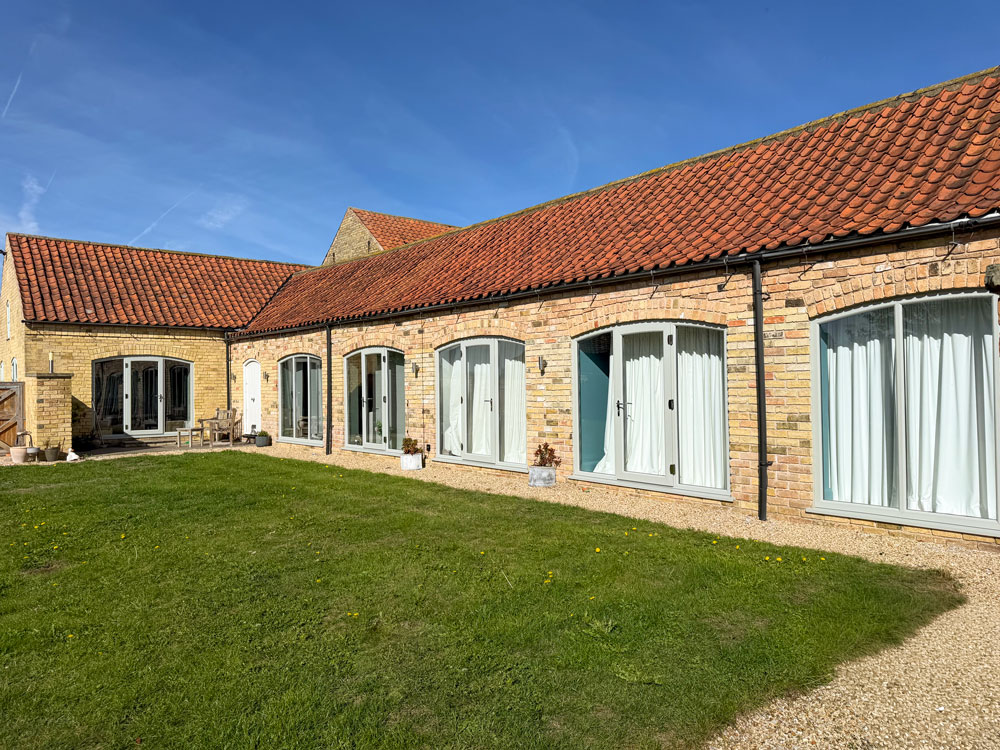 Arched uPVC Windows and Doors Complement Traditional Barn
